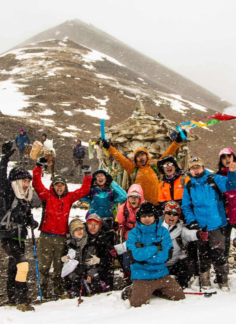 Prayer flags on snowy alpine pass in Dagala
